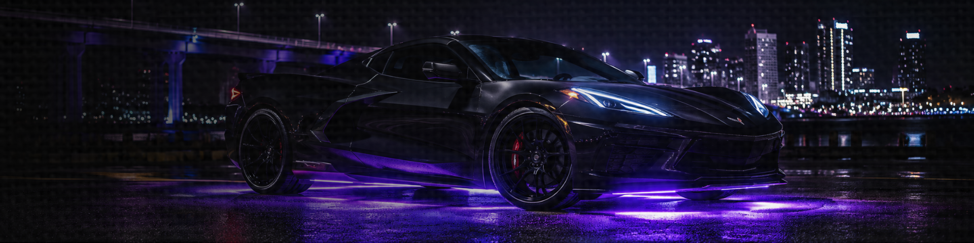 Vehicle with LED underbody lighting and RGB underglow illuminating the ground beneath the vehicle.
